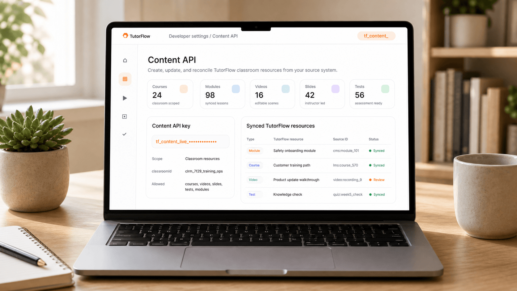 A TutorFlow Content API dashboard shown naturally on a laptop screen, with synced courses, modules, videos, slides, tests, and resource IDs